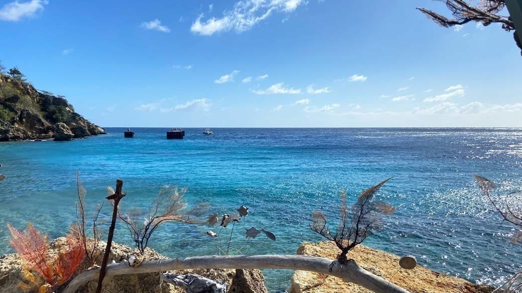 View of the horizon on Tugboat Beach at Caracasbaai in Curacao including coral decoration