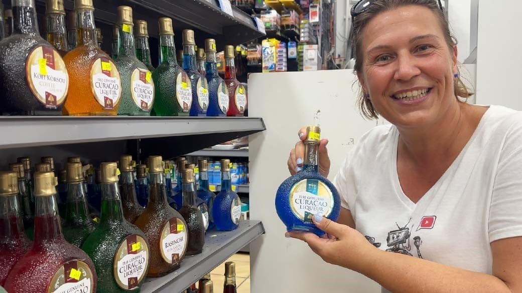 Maike shows the original Blue Curacao liqueur from the Chobolobo manor in the New California Supermarket