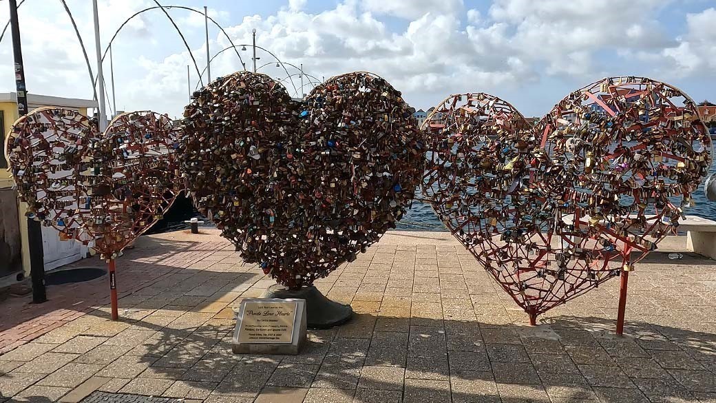 The three Punda Love Hearts full of love locks and the Queen Emma Bridge at Sint Anna Bay